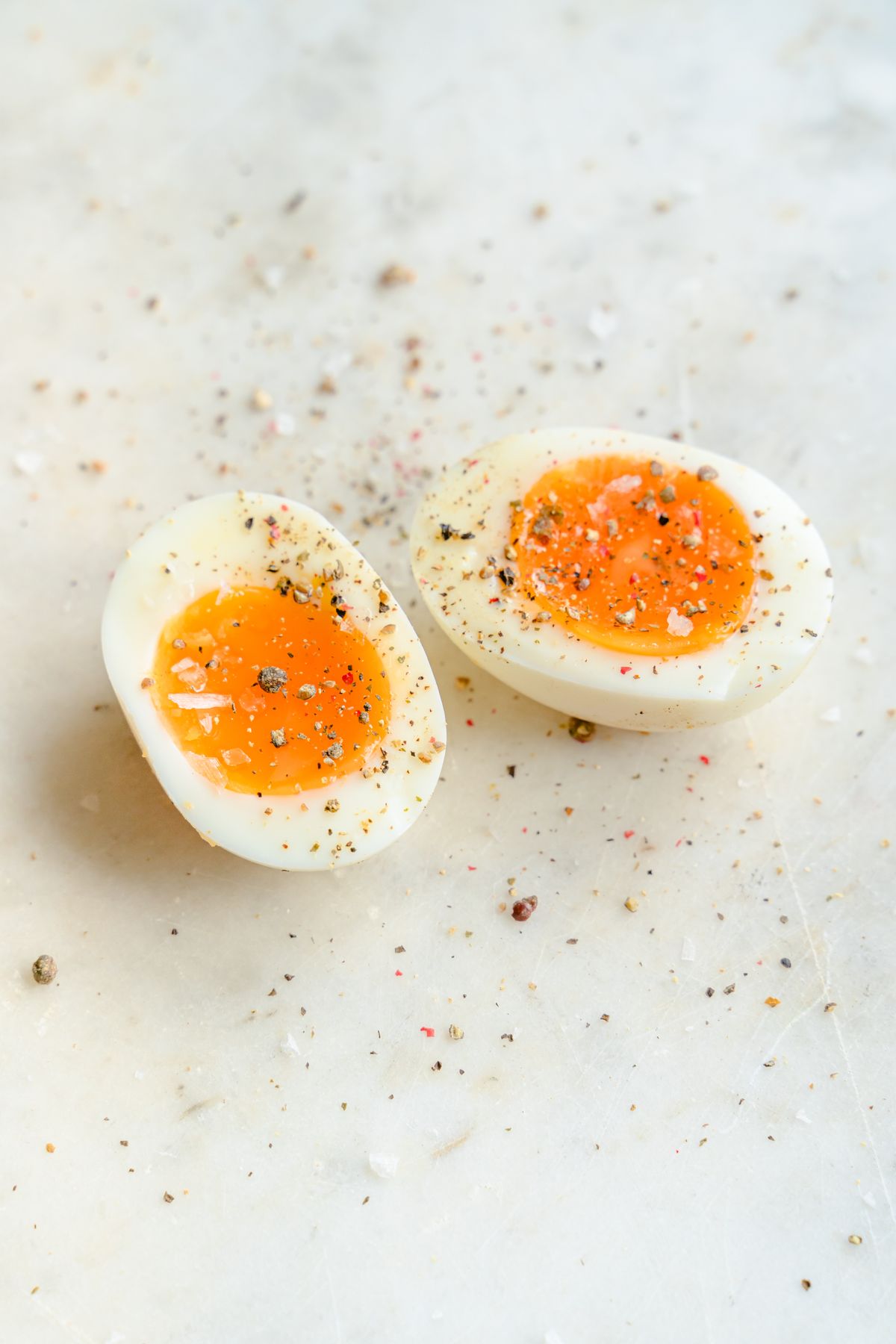Halved boiled eggs with salt and pepper, an easy high protein snack