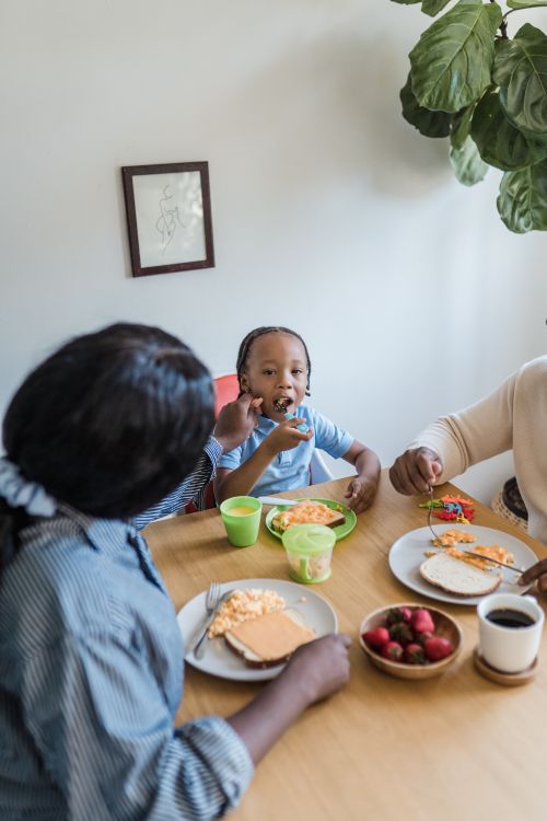 Weekend family breakfast with pancakes and fresh fruit