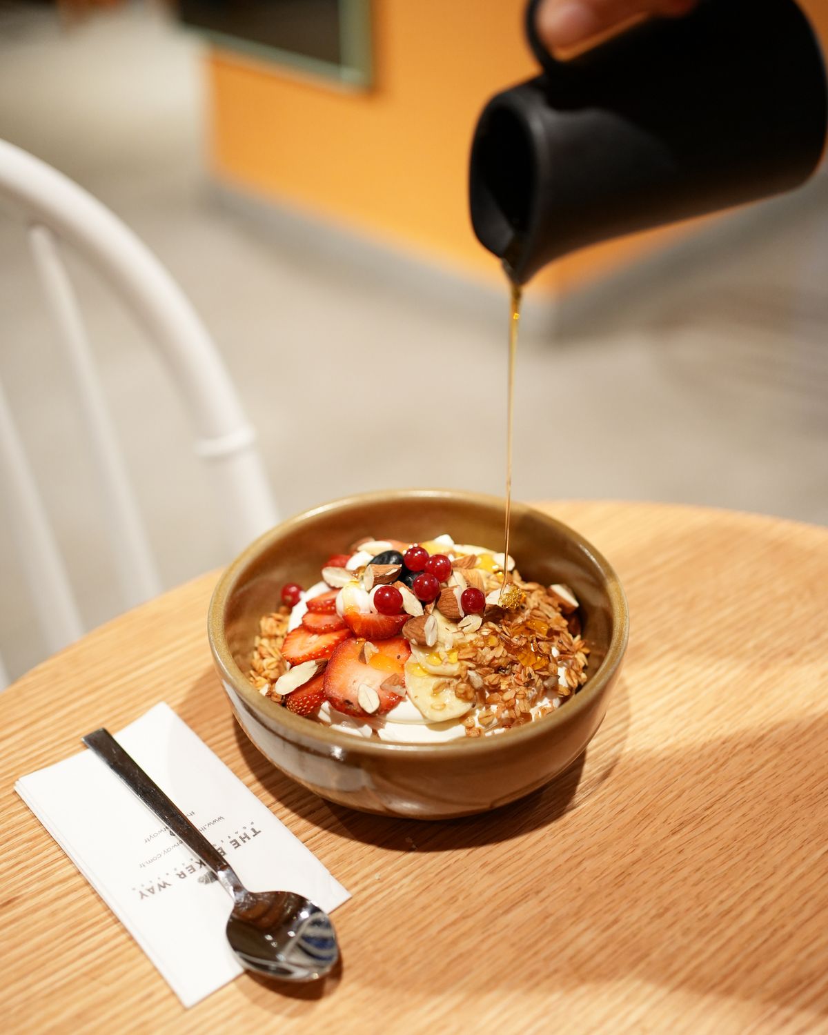 Greek yogurt bowl with strawberries, berries and a drizzle of honey
