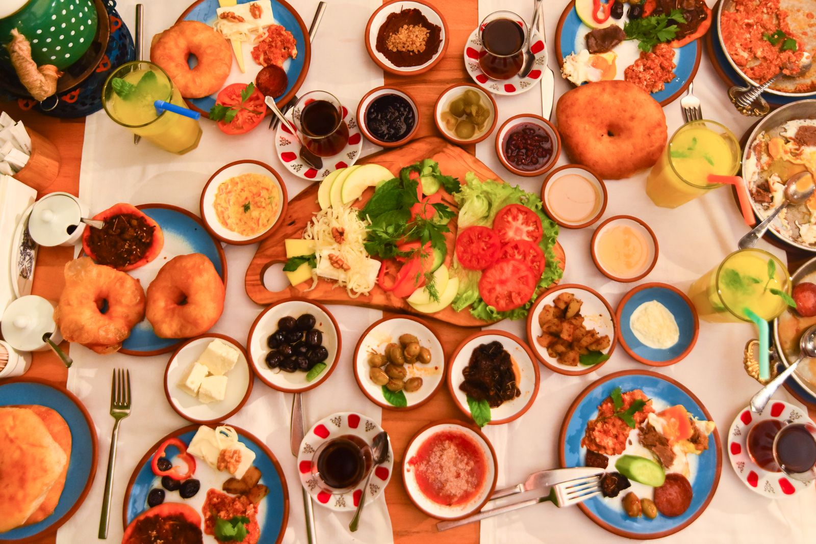 Foods high in protein on a full table spread with eggs, cheese, salads and dips