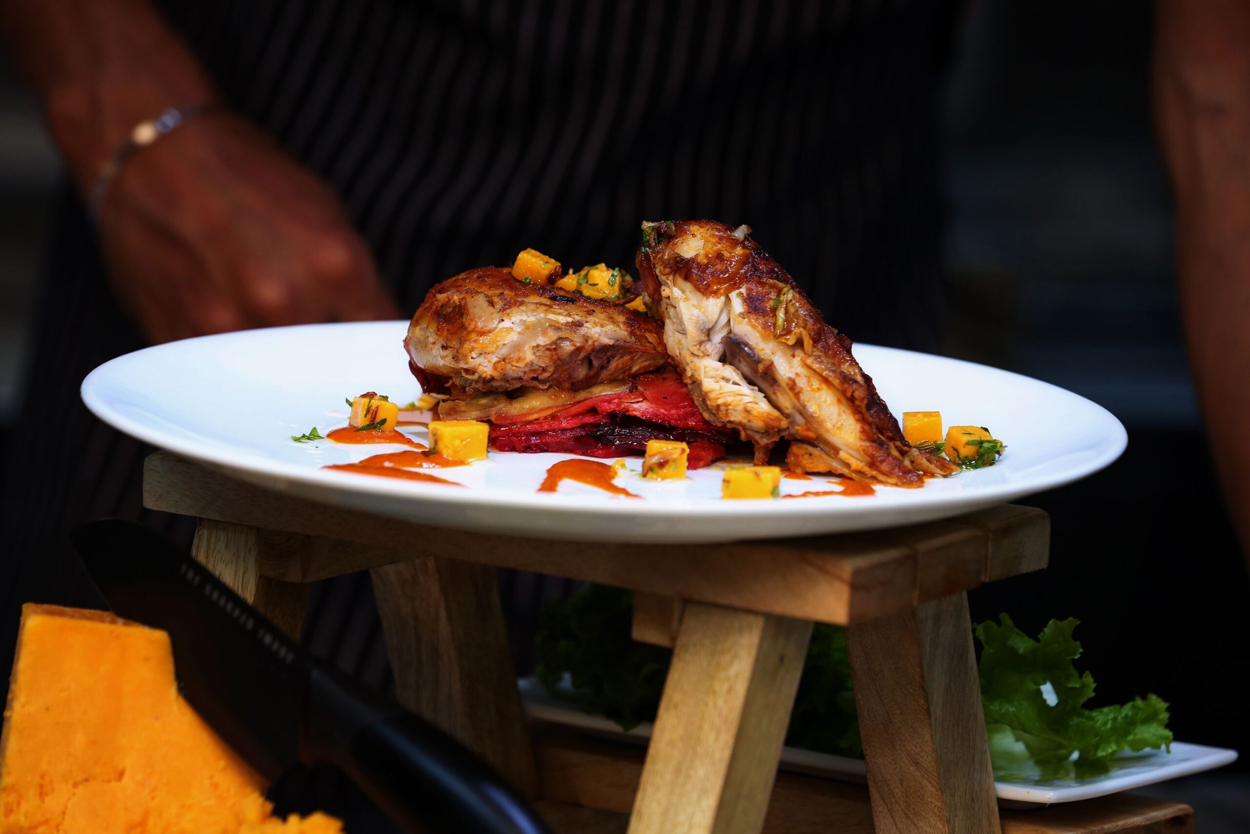Roasted chicken served with colorful vegetables on a white plate, a high protein low carb meal