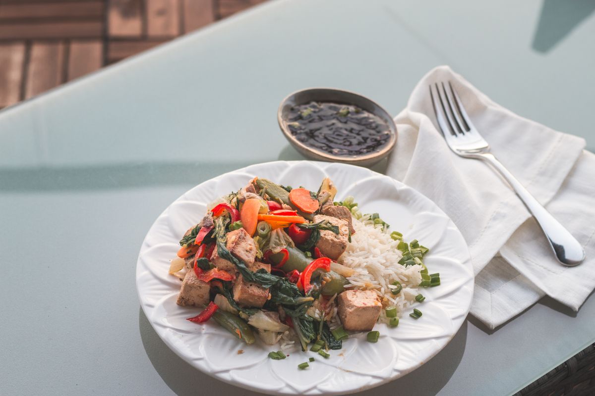 Tofu stir fry with vegetables and rice, a plant based high protein low calorie meal